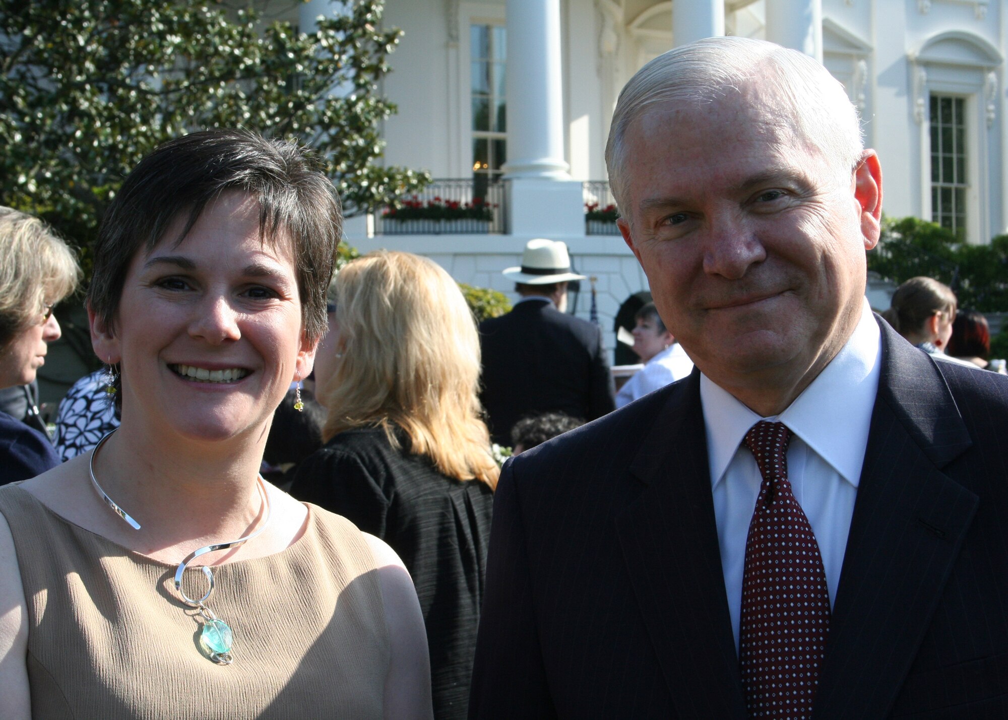 WHITE HOUSE, Washington D.C -- Meighan Altwies wife of Major Aaron Altwies, Deputy Commander of the 8th Civil Engineering Squadron, posed for a photo with Secretary  Robert Gates here May 6.  Mrs. Altwies was invited to attend the Military Spouse Appreciation Breakfast on the south lawn of the White House. This event was held to honor military spouses for their contributions, efforts and support they provide to their spouses whether deployed or at home. (Courtesy photo)  