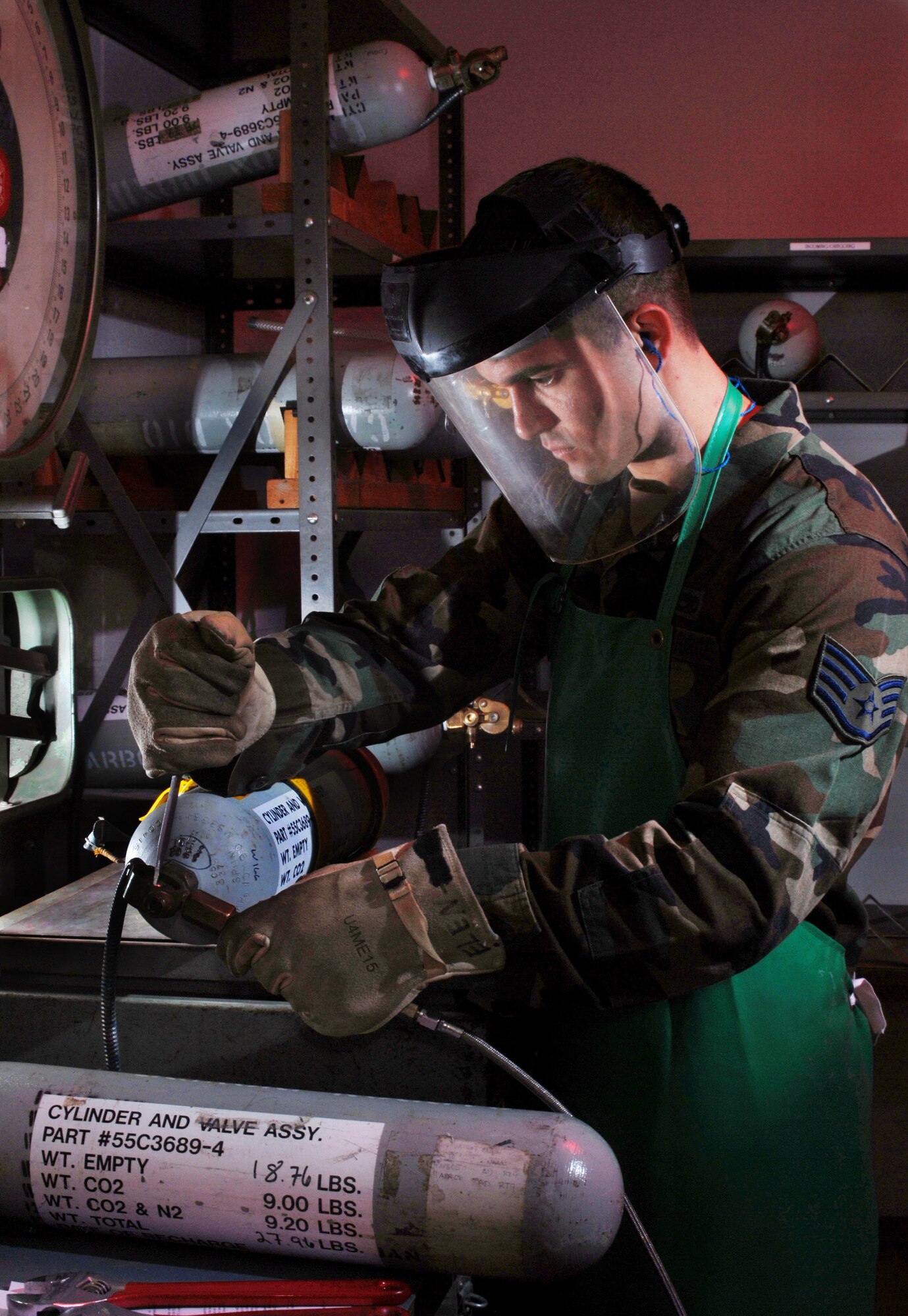 Air Force Reserve Staff Sgt. Jeff Gomez, an electrical and environmental technician from the 452nd Maintenance Squadron, prepares to recharge the carbon dioxide bottle of a 20-man life raft of a KC-135 Stratotanker refueling aircraft during a periodic
inspection. (U.S. Air Force photo by Val Gempis)
