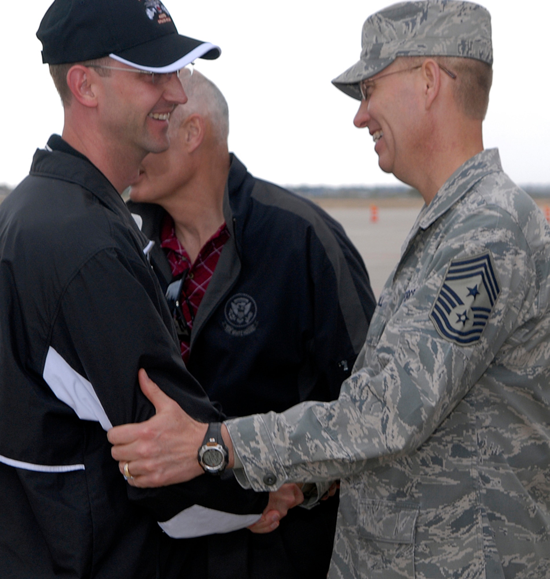PETERSON AIR FORCE BASE, Colo. -- Col. Wayne McGee, 460th Space Wing commander, is greeted by Chief Master Sgt. Richard Small, Air Force Space Command command chief, May 7 on the Peterson Air Force Base flightline. Guardian Challenge team members descended upon the southern Colorado base as the teams prepared for three days of events, including a golf tournament, space and missile forum and an awards and dinner banquet May 9. The Guardian Challenge competition pits the command's several space wings against each other to see whose the "best of the best" in areas of expertise, including security forces, communications, missile combat and satellite operations. (U.S. Air Force photo by Mr. Dennis Howk)