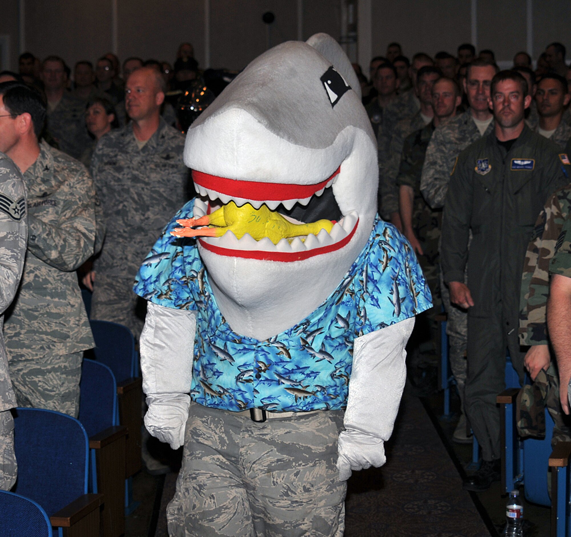 Snark the Shark, the mascot of the 45th Space Wing, based at Patrick Air Force Base, Fla., stands at attention as the official party for Guardian Challenge 2008 leaves the Peterson Air Force Base auditorium May 8 at this southern Colorado base. The teams descended on Peterson May 7 as they prepared for three days of GC events, including a golf tournament, space and missile forum and awards and dinner banquet May 9. The Guardian Challenge competition pits the command’s several space wings against each other to see whose the “best of the best” in areas of expertise, including security forces, communications, missile combat or satellite operations. (U.S. Air Force photo/Larry Hulst)