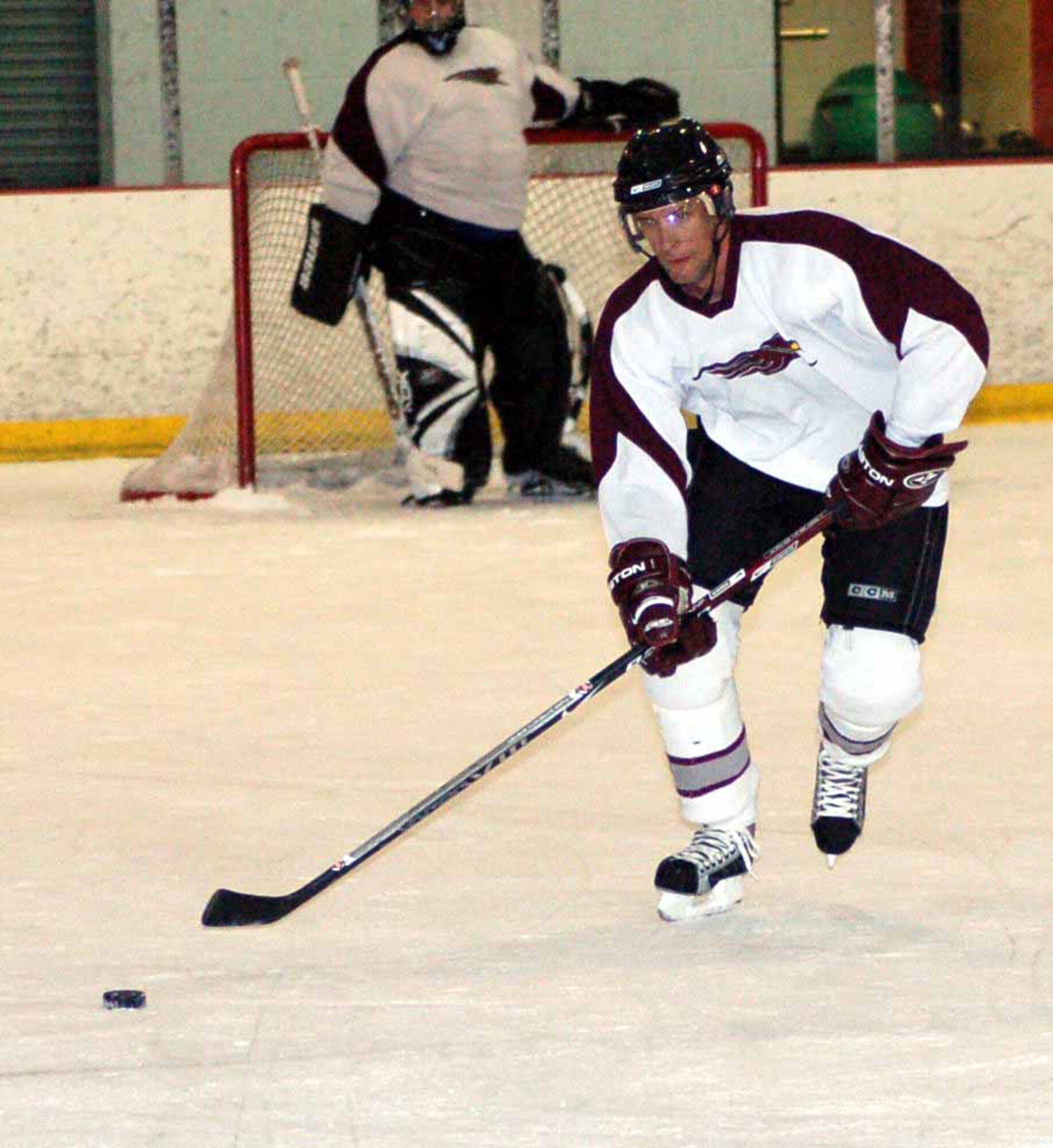 Tinker Hawks I defenseman Jon Ellysen leads a rush up the ice during the third period of a playoff game May 4.  The Flames beat the Hawks 8-2.  (Air Force photo by John E. Banks)
