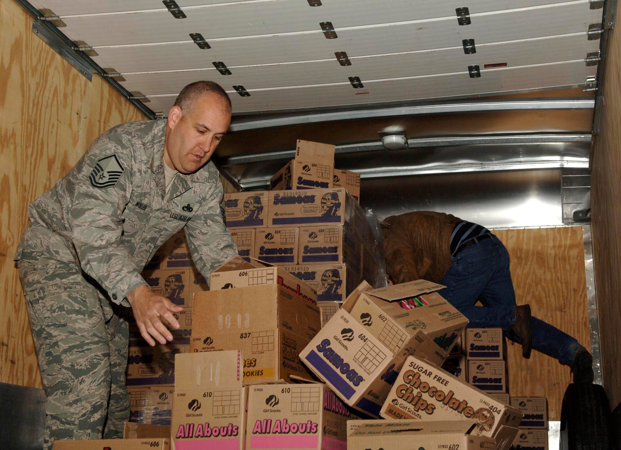 FAIRCHILD AIR FORCE BASE, Wash. – Master Sgt. Scott Woller, 92nd Mission Support Squadron Airman & Family Readiness Center, loads cases of Girl Scout cookies onto a truck at the Crown warehouse in Spokane Valley, Wash., May 7. The cookies were donated by 32 different counties across the states of Washington, Idaho, and Oregon for military members. (U.S. Air Force photo / Airman 1st Class Darlene West)