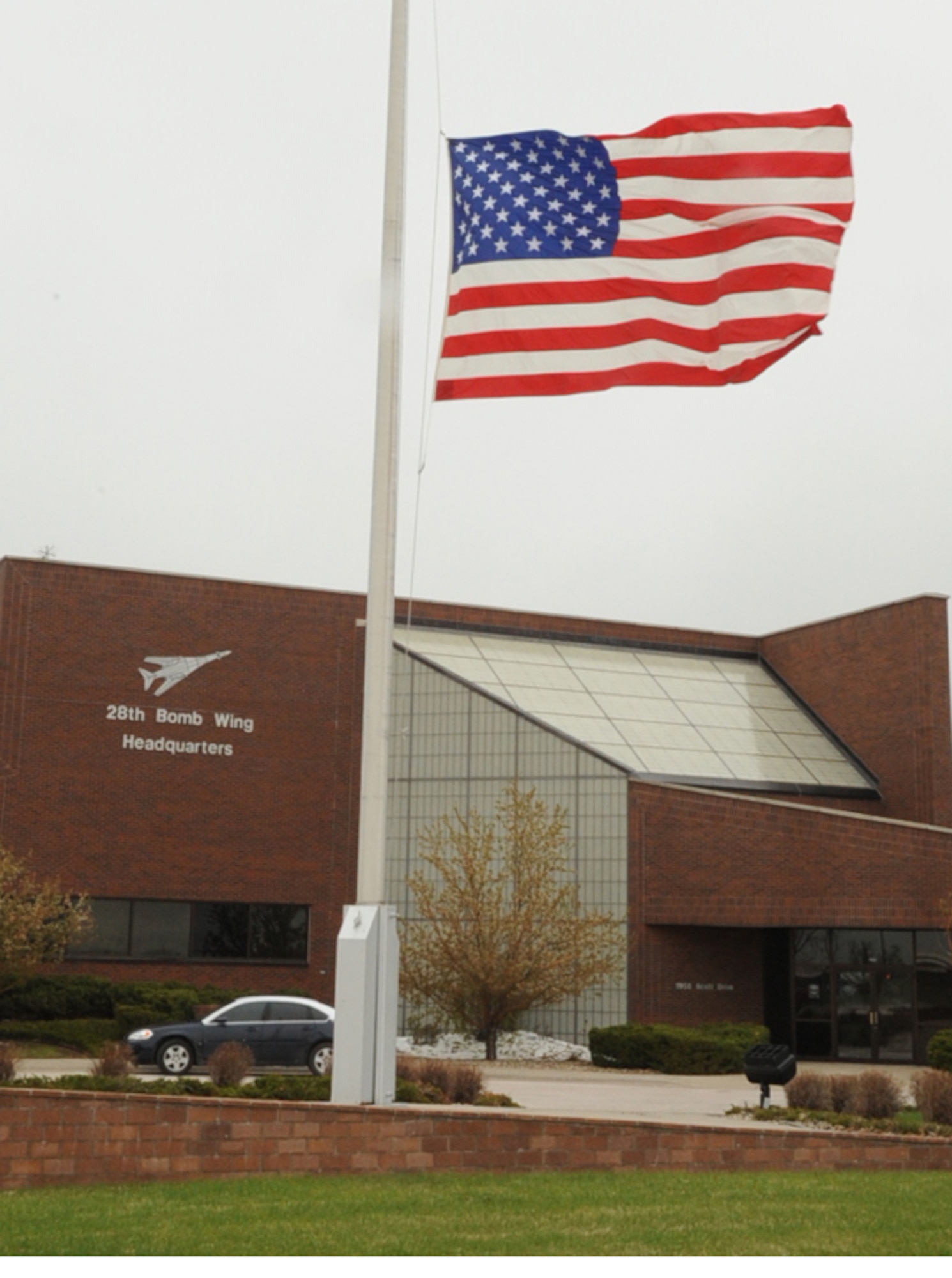 The U.S. flag at Ellsworth headquarters is flown at half-staff May 8 in remembrance of Senior Airman Jonathon Yelner, 28th Aircraft Maintenance squadron weapons load crew member. Airman Yelner lost his life April 29 when his vehicle encountered an improvised explosive device; South Dakota Governor Mike Rounds asked that flags be flown at half-staff state-wide in honor of Airman Yelner. (U.S. Air Force photo/ Airman 1st Class Adam Grant)