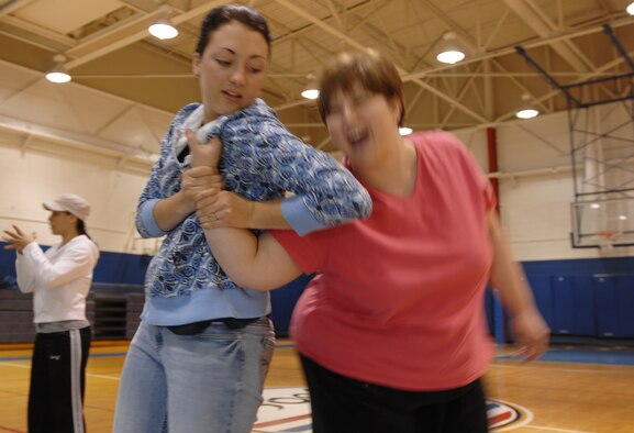 WHITEMAN AIR FORCE BASE, Mo. - Meg Martin (left) defends against an "assailant" during a self defense class May 8. The self defense class was part of Spouses' Week, during which military spouses were the focus of a week's worth of activiites. (U.S. Air Force photo.Staff Sgt. Jason Barebo)