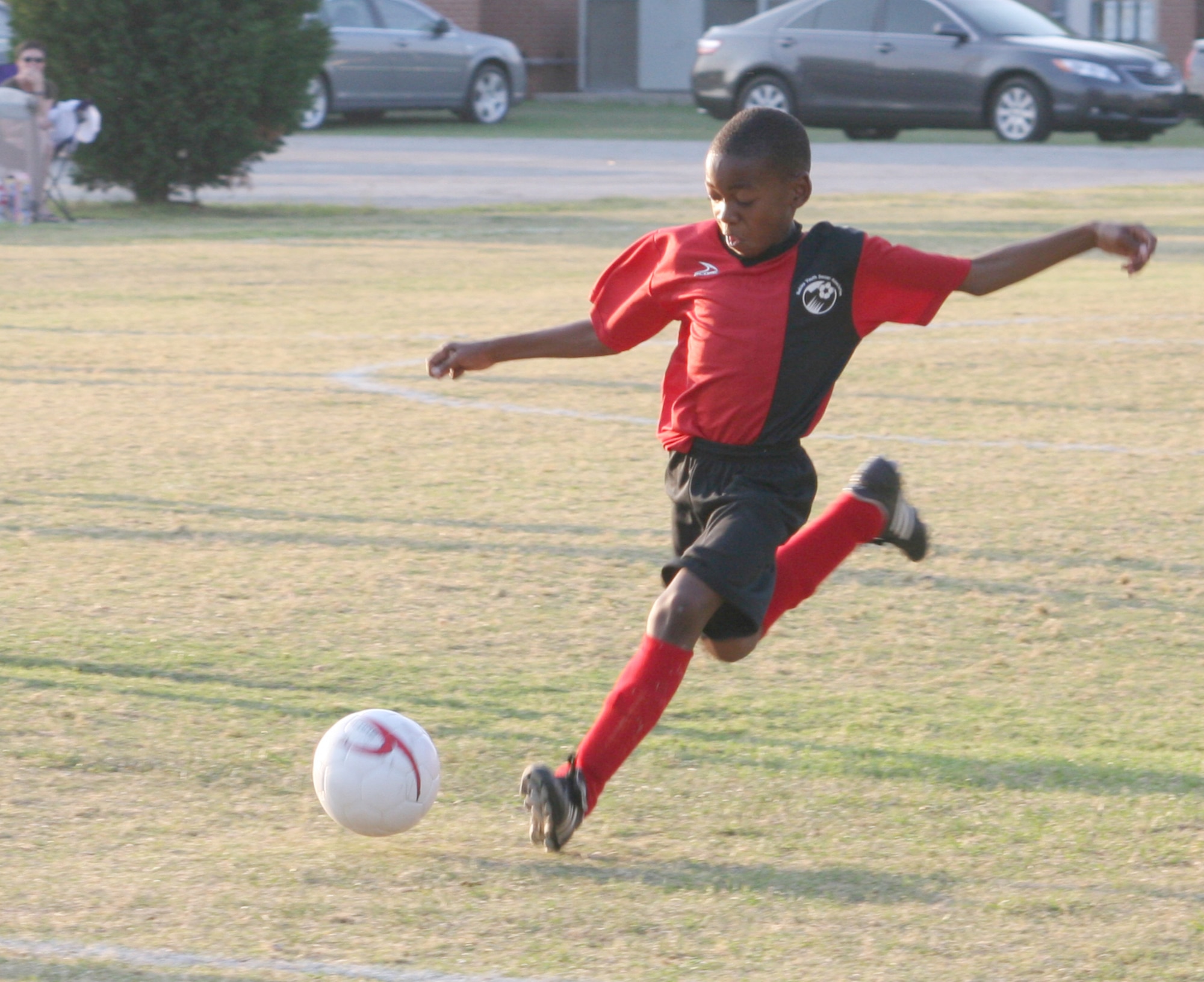 EJ Lindsey, 9, with a powerful strike, scored three goals during game one of the tournament. His goals helped propel his team to a 6-0 victory and a chance to compete in the championship game Saturday. U. S. Air Force photo by Amanda Creel