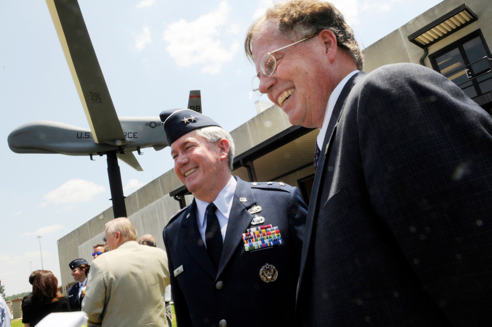 Maj. Gen. Tom Owen, Warner Robins Air Logistics Center commander and Steven Enewold, Northrop Grumman vice president and deputy of high altitude long endurance systems are all smiles after the dedication ceremony of a Global Hawk model donated to Robins to highlight the continued success of the United States Air Force and the Northrop Grumman partnership. U. S. Air Force photo by Sue Sapp