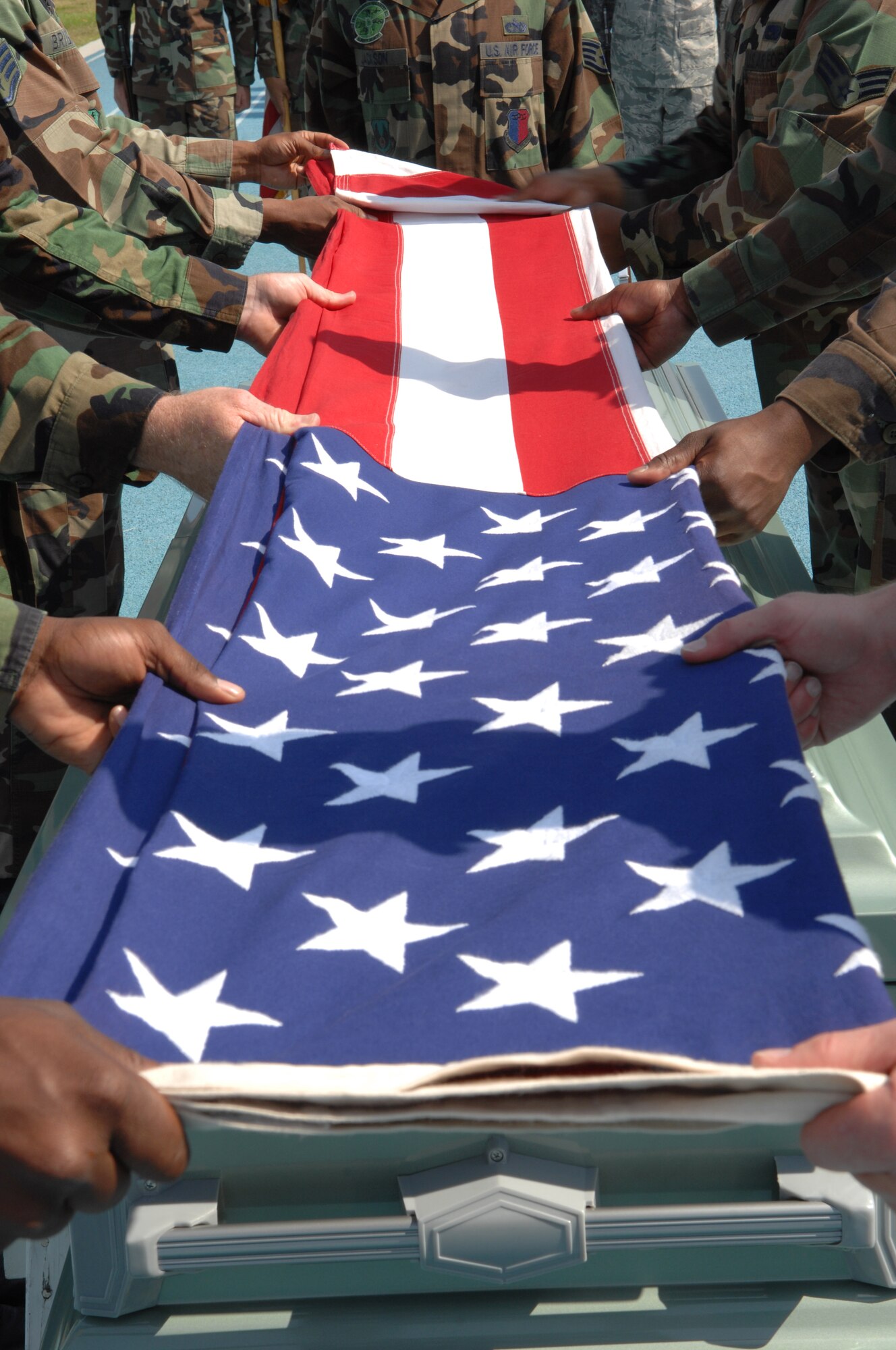 MOODY AIR FORCE BASE, Ga. – Members from various bases fold the U.S flag during their graduation ceremony here May 7.  The mock funeral demonstrates the skills Honor Guard members learned during ttheir eight day intensive training course. (U.S. Air Force photo by Senior Airman Angelita Lawrence) (Released)