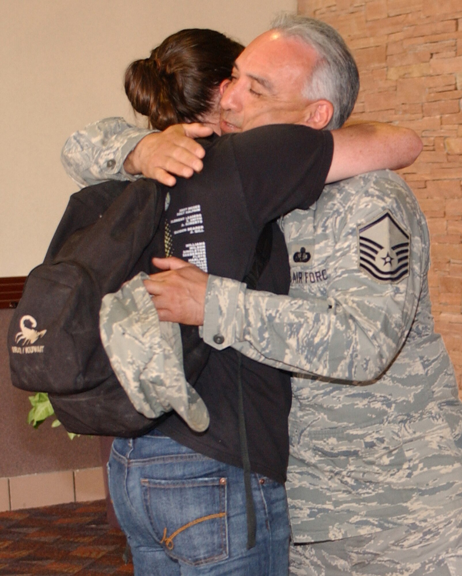 Senior Airman Tasha Boatman receives a big hug from fellow squadron member Master Sgt. Manual Perez May 7 at the Colorado Springs airport. Airman Boatman re-deployed with members of both the 21st Services and Space Communications Squadrons after four-and six-month deployments to Southwest Asia. Both Airman Boatman and Sergeant Perez are assigned to the 21st SVS. (U.S. Air Force photo/Margie Arnold)