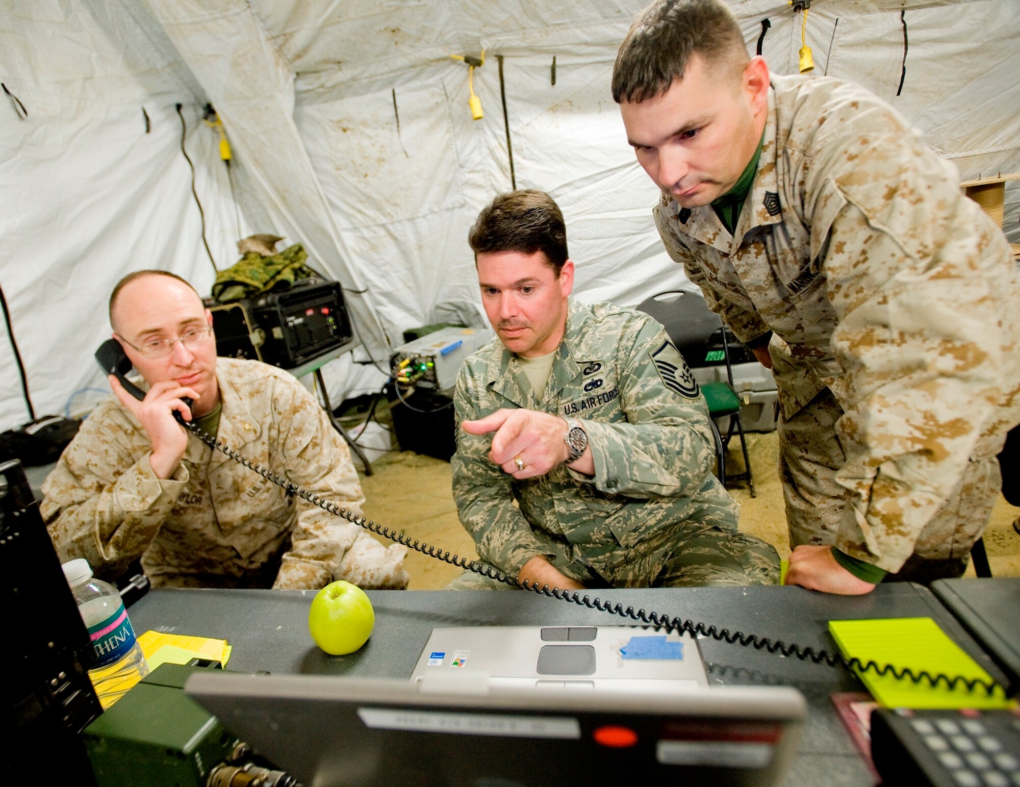 EIELSON AIR FORCE BASE, Alaska—U.S. Marine Major John Naylor, U.S. Air Force Master Sergeant Joe Dibenepetto, and U.S. Marine Master Sergeant Mark Cain work on sending data links of radar information to U.S. aircrafts at Eielson Air Force Base, Alaska on May 6, 2008. The Marines is working with the Air Force to train on emerging joint tactics, techniques and procedures for the Northern Edge exercise. Northern Edge provides U.S. military units a cost effective and low risk training opportunity  for regional and world wide crises.(U.S. Air Force Photo by Airman 1st Class Jonathan Steffen) (RELEASED)