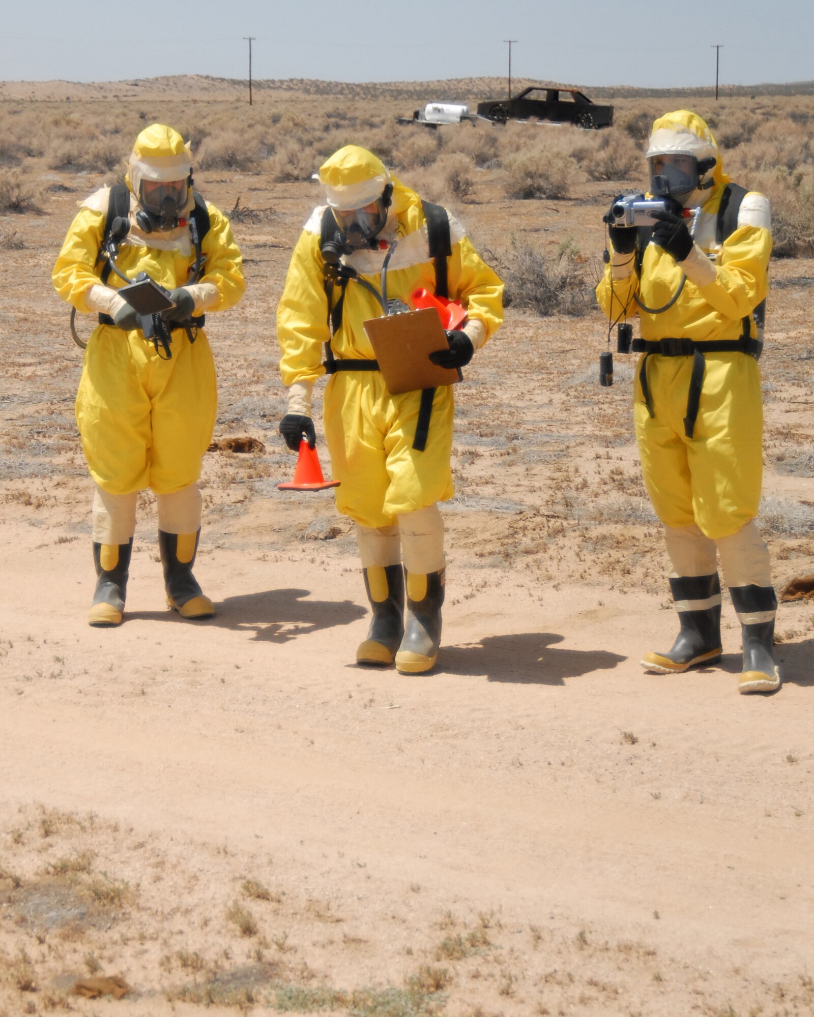An explosive ordnance disposal team marks off the distance from a simulated explosive device during a base-wide exercise here May 7. The two-day exercise was based on a simulated C-17 Globemaster III crash on the base. (U.S. Air Force photo by Airman 1st Class William O'Brien) 