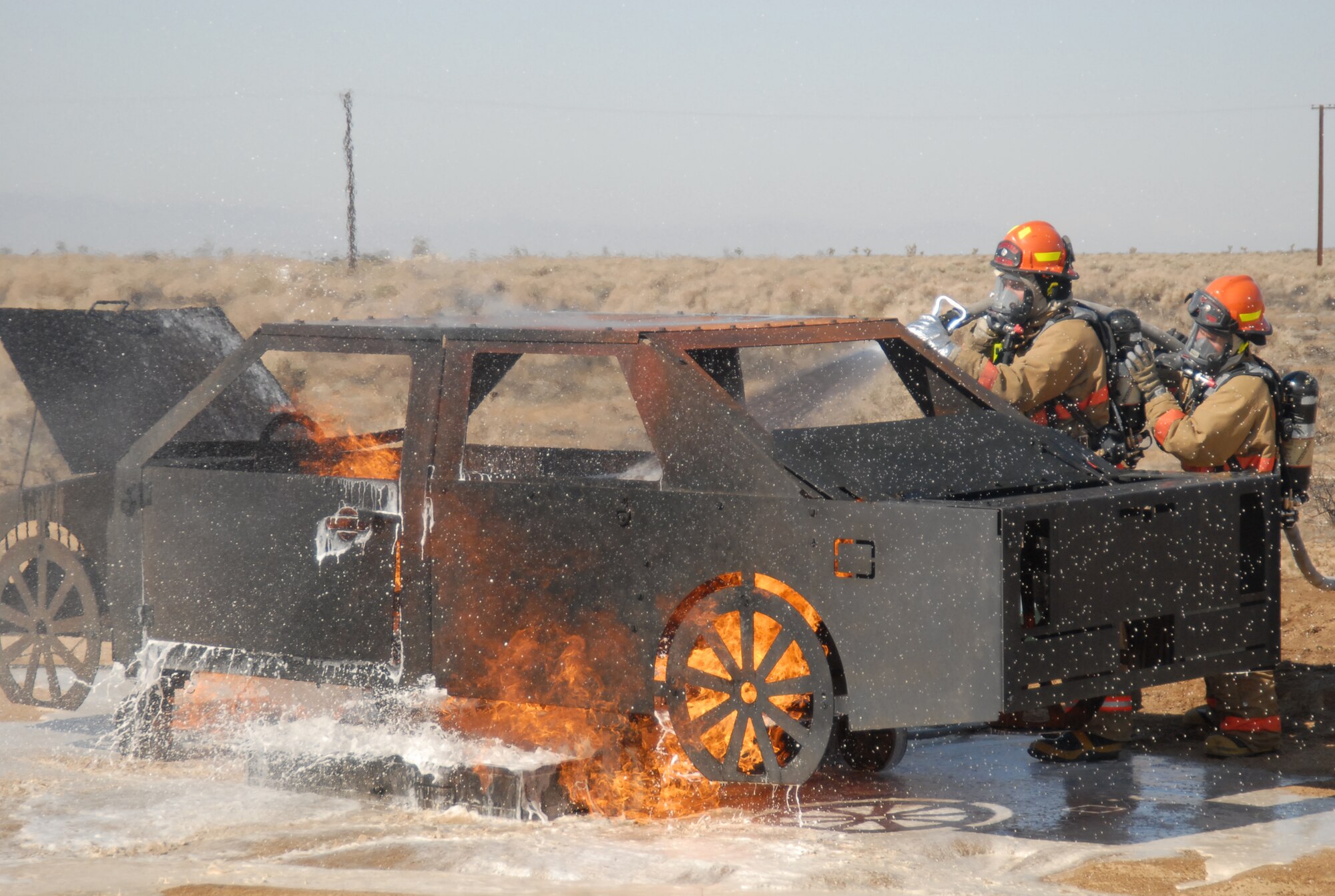 Edwards' firefighters extinguish the flames from a car fire after a simulated crash of C-17 Globemaster III crash here May 7. The base held a two-day exercise to test the base's emergency response capabilities. (U.S. Air Force photo by Airman 1st Class William O'Brien) 