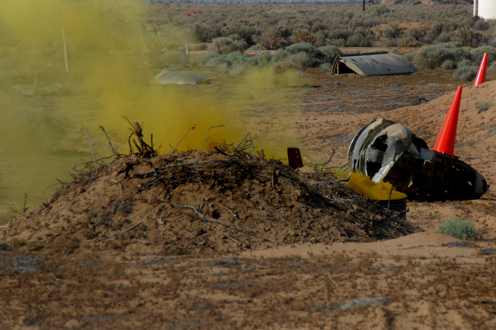 Smoke billows from a simulated C-17 Globemaster III plane crash behind Camp Corum here May 7 during an exercise to test the base’s emergency response capabilities. The two-day exercise not only tested emergency responders, but also tested the base's ability to accommodate a large investigation team. (U.S. Air Force photo by Airman 1st Class William O'Brien) 