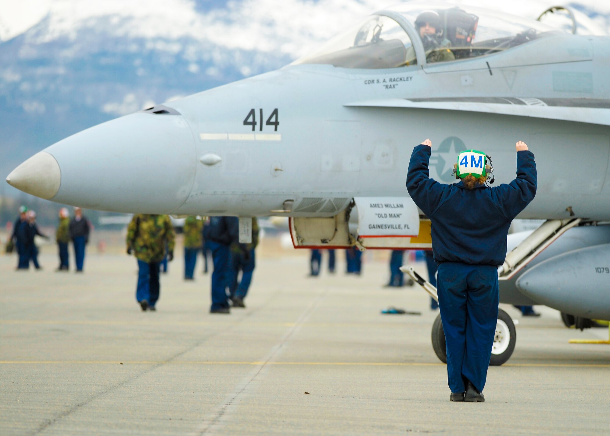 A Navy plane captain taxis out one of nearly 50 Navy F/A-18 Hornets during a Northern Edge exercise May 6. Nearly 5,000 DOD members and 120 aircraft are participating in the 2008 Northern Edge. (U.S. Air Force photo/Master Sgt. Keith Brown)