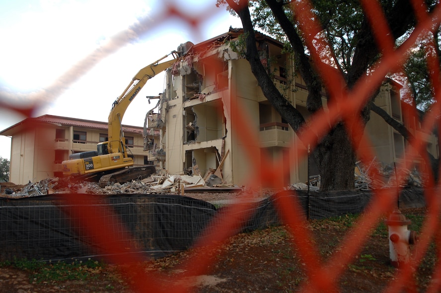BARKSDALE AIR FORCE BASE, La. - A contractor operates a bulldozer to tear down one of three dormitories scheduled for demolition April 25. Once the area is clear of the 23 year old dorms, the space will be expanded parking for current dorm residents. (U.S. Air Force photo by Airman 1st Class Joanna M. Kresge) (Released)