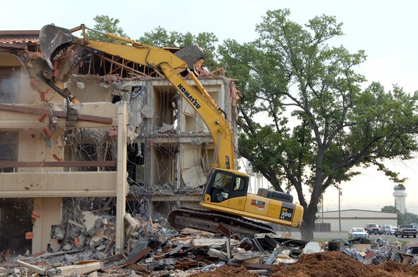 BARKSDALE AIR FORCE BASE, La. - A contractor operates a bulldozer to tear down one of three dormitories scheduled for demolition April 25. Once the area is clear of the 23 year old dorms, the space will be expanded parking for current dorm residents. (U.S. Air Force photo by Airman 1st Class Joanna M. Kresge) (Released)
