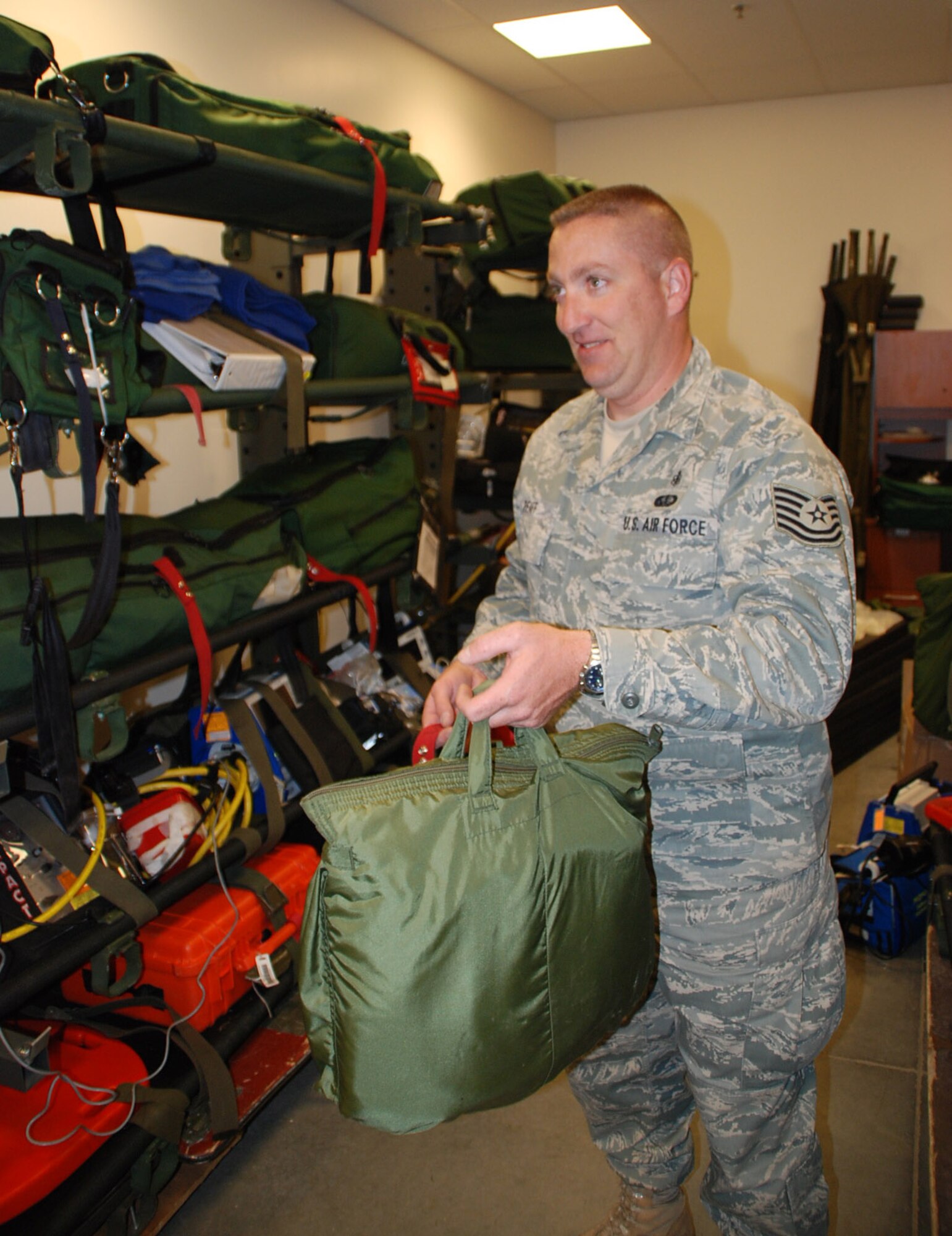 Tech Sgt. Christopher Pfaff, medical logicstics at the 932nd Airlift Wing, has been in 932nd since 1997 and served over 17 years in the military.  Here he helps get gear packed up for other members to fly aboard a C-130.  He is part of the Air Force Reserve's 932nd Aeromedical Evacuation Squadron based at Scott Air Force Base.  Photo/Tech Sgt. Gerald Sonnenberg