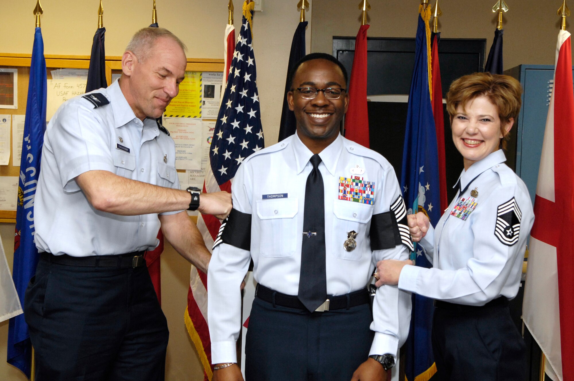 HANSCOM AFB, Mass. - Col. Tom Schluckebier, 66th Air Base Wing commander, and Chief Master Sgt. Ginger Thompson “tack on” new stripes to Hanscom’s newest chief, Chief Master Sgt. Al Thompson, during a promotion ceremony April 30 at the Security Forces Squadron. Chief Thompson will be recognized May 30 during the Chiefs Recognition Ceremony at the Minuteman Club. For details, contact Chief Master Sgt. Mike McCoy at (781) 377-1004.   (U.S. Air Force Photo by Mark Wyatt)
