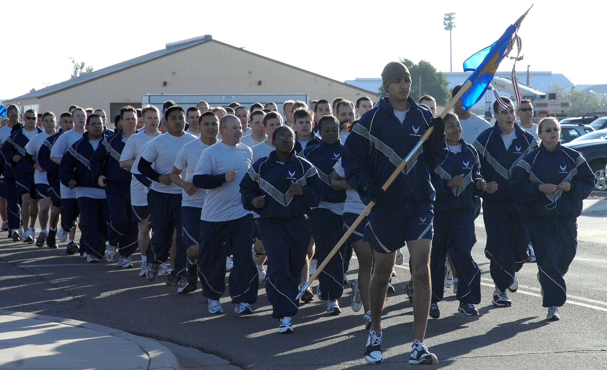 CANNON AIR FORCE BASE, N.M. - Senior Airman Alex Moreno, 27th Special Operations Communications Squadron, holds the guidon while leading the 27th SOCS during the Commando Run May 8. The Commando Run is done the second Thursday of every month as part of the monthly wing training day. (U.S. Air Force photo/Airman 1st Class Liliana Moreno)