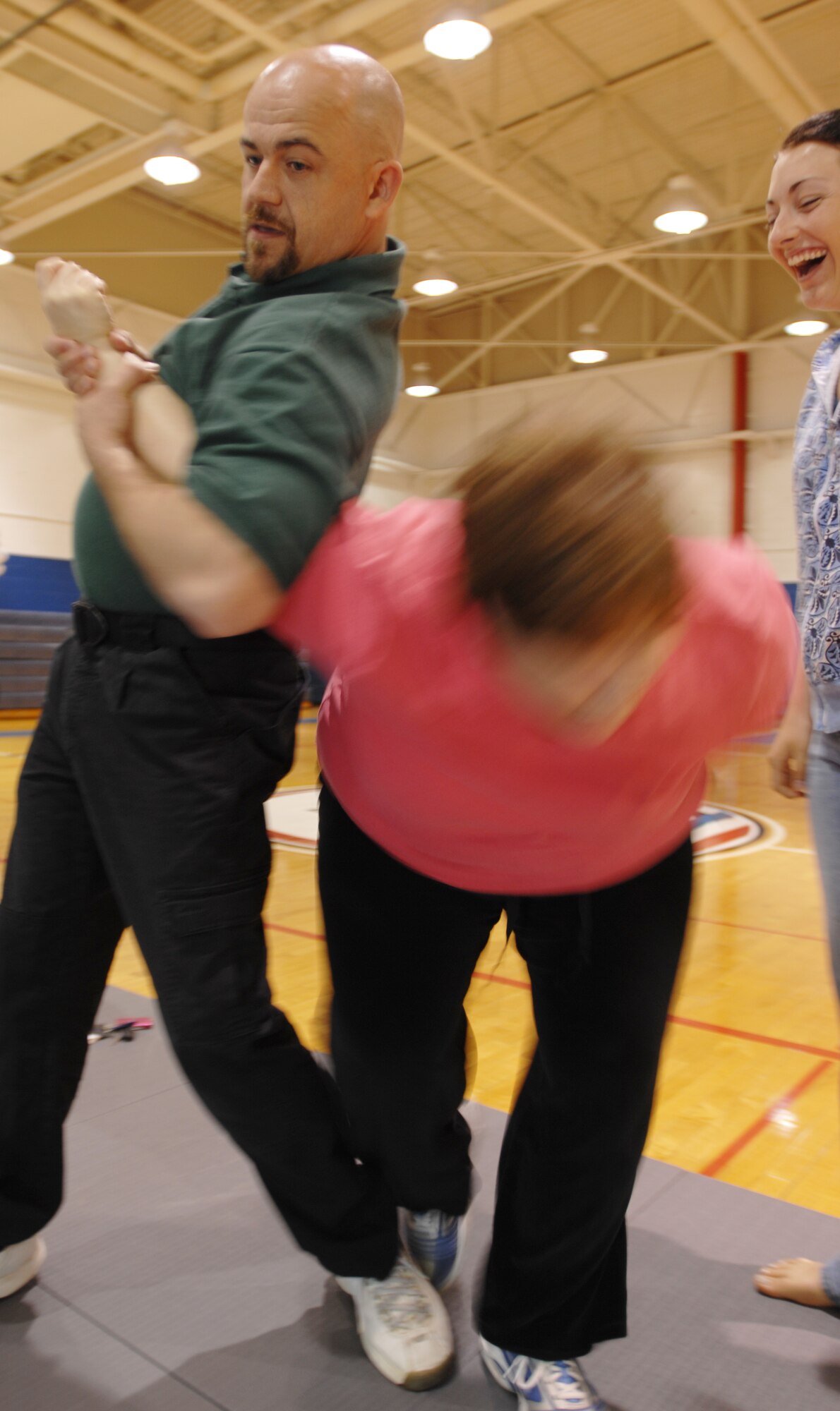 WHITEMAN AIR FORCE BASE, Mo. - Self defense instructor Billy Matheny,
509th Security Forces Squadron, defends against an "assailant" during a self defense class May 8. the self defense class was part of Spouses' Week, during which military spouses were the focus of a week's worth of activiites. (U.S. Air Force photo.Staff Sgt. Jason Barebo)