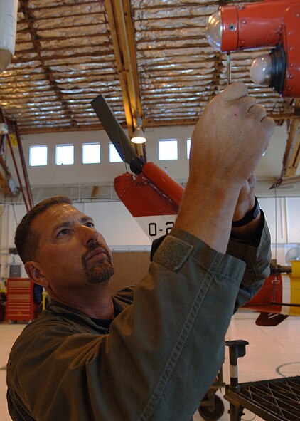 HOLLOMAN AIR FORCE BASE, N.M.--Mr. Bill Bixler, Army Air Branch Range Operations and Range Control flight engineer, repairs a broken bulb on a UH-1H helicopter before it's flight inspection here May 6, 2008. (U.S. Air Force photo/Airman 1st Class John D. Strong II)