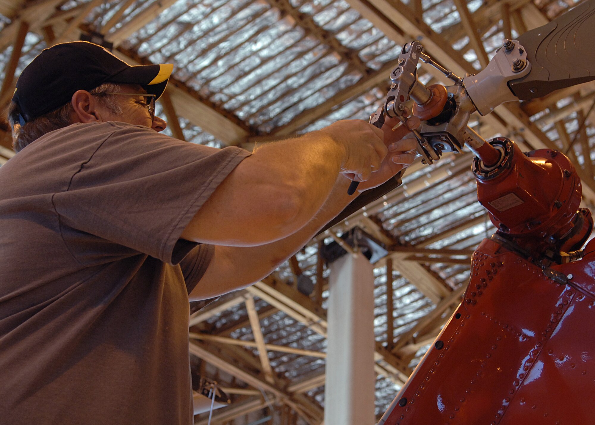 Mr. Dave Stech, Army Air Branch Range Operations and Range Control mechanic, fixes a rotor on the UH-1H helicopter before it's flight inspection here May 6, 2008. (U.S. Air Force photo/Airman 1st Class John D. Strong II)
