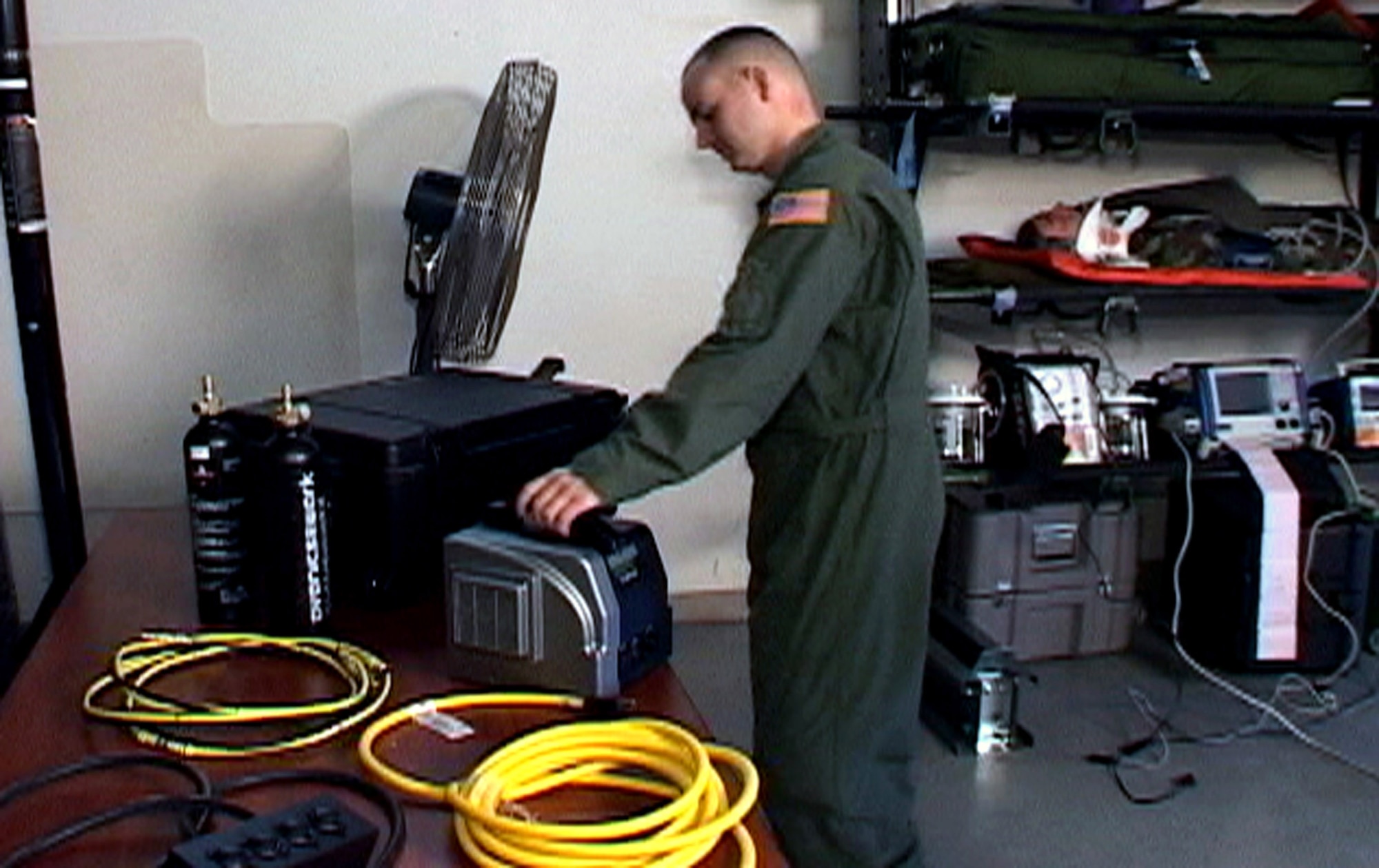 An Air Force medical technician from the 375th Aeromedical Evacuation Squadron, Scott Air Force Base, Ill., prepares the Jadoo portable electronic power system for use with aeromedical power equipment as part of an Air Mobility Battlelab demonstration at Scott in February 2008.  The demonstration was for the battlelab's Portable A 375th Aeromedical Evacuation Squadron medical technician prepares the Jadoo portable electronic power system for use with aeromedical power equipment as part of an Air Mobility Battlelab demonstration  in February at Scott Air Force Base, Ill. The demonstration was for the battlelab's Portable Electronic Power Supply for Aeromedical Evacuations initiative. The demonstration proved successful and the Air Mobility Battlelab, located in the Air Force Expeditionary Center at Fort Dix, N.J., has recommended it to Air Mobility Command for use. (U.S. Air Force photo/Art Tollefson)