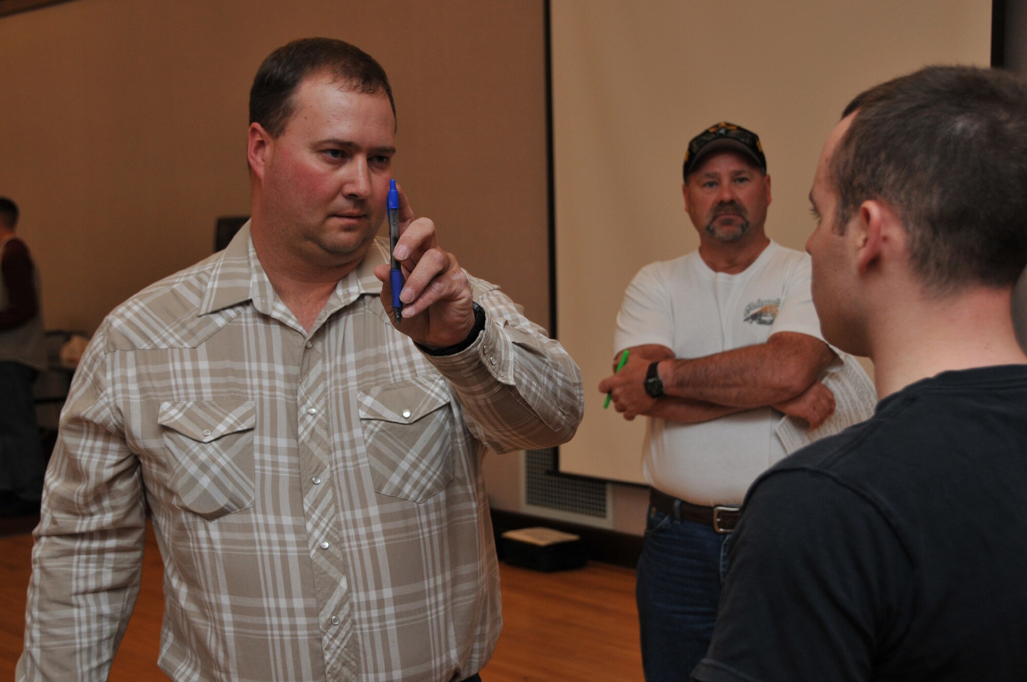 Cascade County reserve deputy sheriff Andy LeBrun asks 341st Missile Security Forces Squadron volunteer Airman Christopher Peter to follow the tip of the pen while he analyzes the Airman's eye movements. The testing was part of Field Sobriety Training at the Civic Center April 29 that was paid for with federal grant money provided to the Enforcing Underage Drinking Laws committee. (U.S. Air Force photo/John Turner)