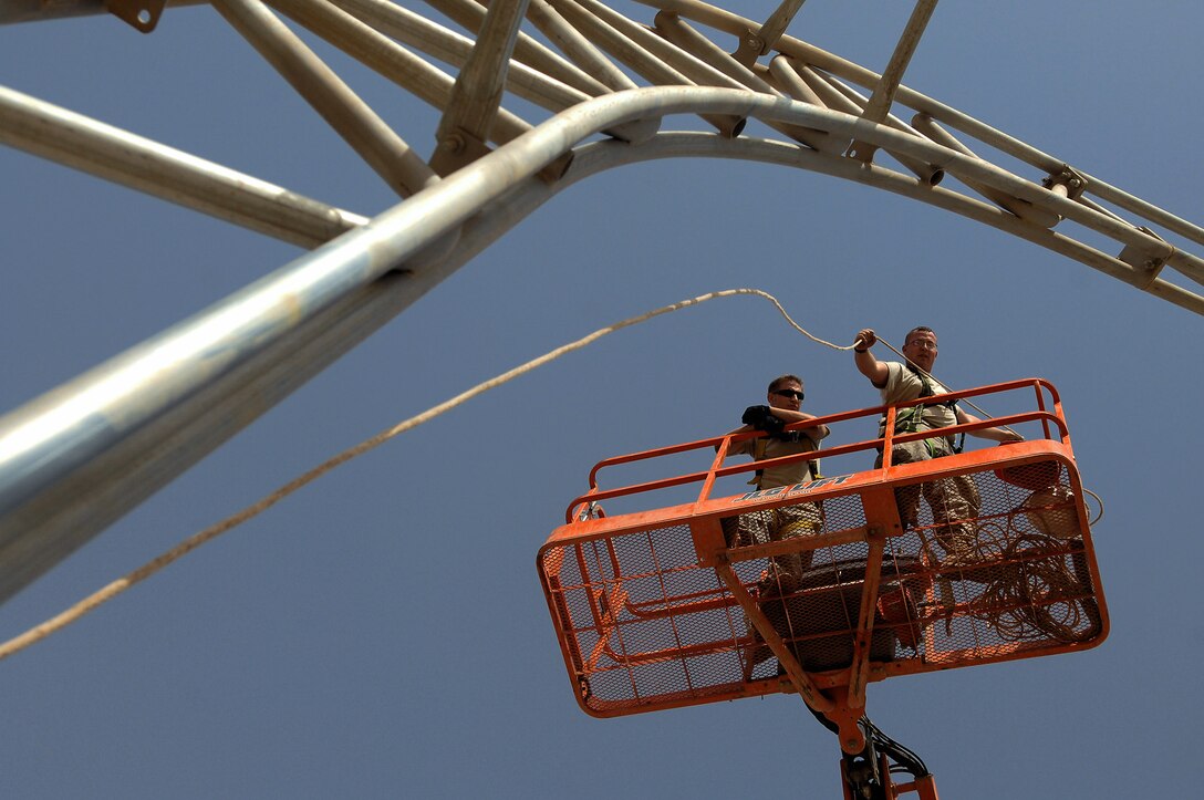 Staff Sgt. Karl Ferree raises a lead rope over the skeleton of a big top shelter May 7 at Balad Air Base, Iraq. The shelter was moved from its previous location to deconflict with flightline operations. Sergeant Ferree is a 332nd Expeditionary Civil Engineer Squadron structural engineer deployed from Luke Air Force Base, Ariz. (U.S. Air Force photo/Senior Airman Julianne Showalter) 