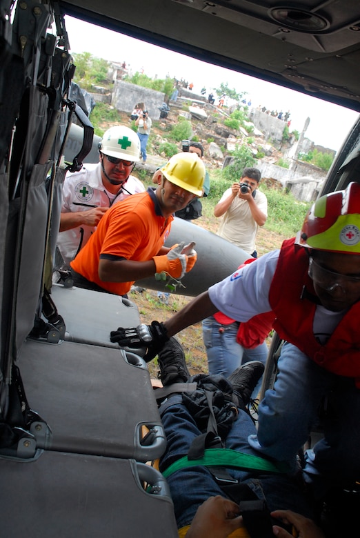 COMALAPA AIR BASE, El Salvador - Salvadoran rescue personnel give the OK after strapping ?injured? personnel into a Joint Task Force-Bravo Blackhawk helicopter May 6 during Fuerzas Aliadas Humanitarias 2008. The landing zone, located on top of a 3,000 foot mountain, was adjacent to the ruins of a collapsed coffee factory destroyed by earthquake more than seven years ago. (U.S. Air Force photo by Tech. Sgt. William Farrow)