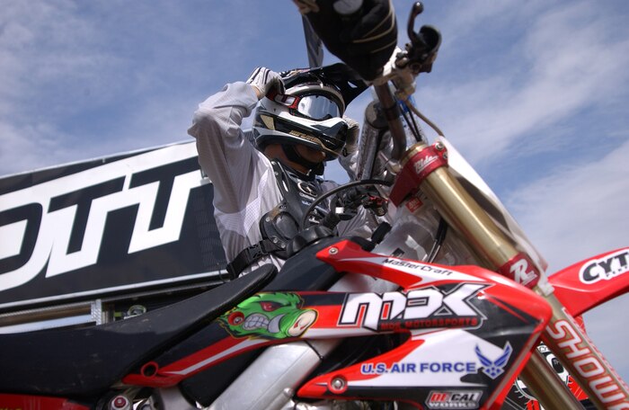 Heath Voss,western region supercross competitor, puts on his riding gear and prepares to enter the qualification heats for the 2008 Monster Energy Supercross Championship held at Sam Boyd Stadium May 5, Las Vegas, Nev.  Although not financially supported by the U.S. Air Force,  Voss displays the Air Force logo in various places on his bike, equipment, and trailer to show his support and admiration for the U.s. Air Force. he finsihed 12th in the race, 11th in the series, and was the world supercorss champion in 2004.(U.S. Air Force photo/Airman 1st Class Ryan Whitney)