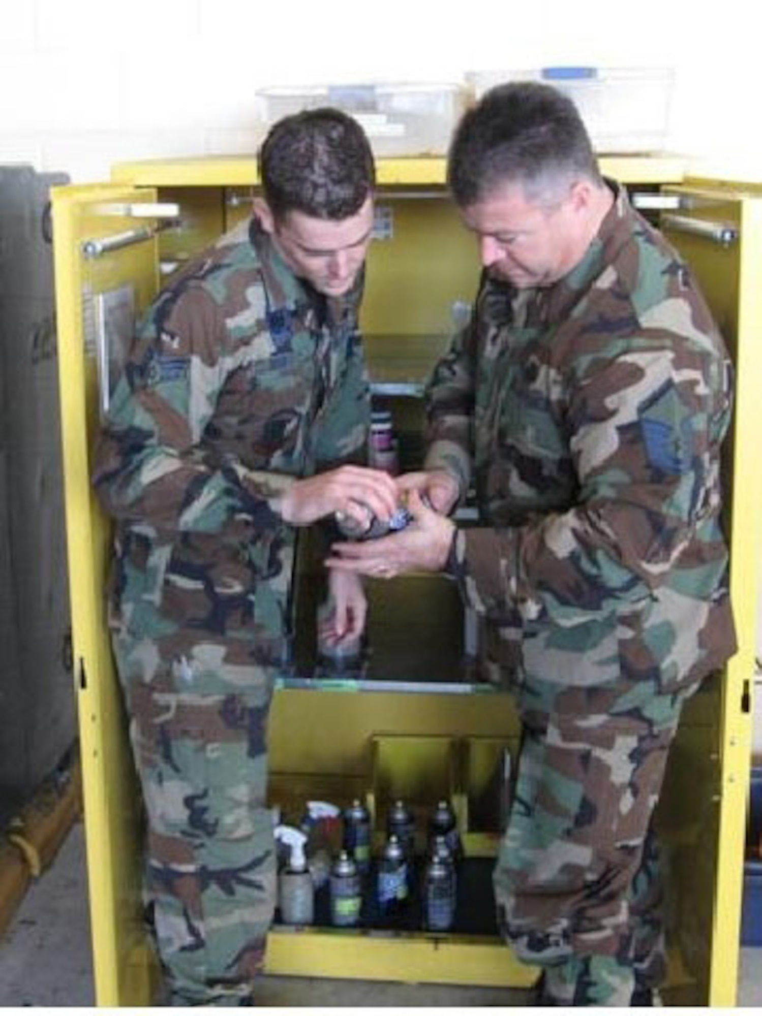 Senior Airman Sidney Bright, 33rd Aircraft Maintenance Squadron issue point 45 manager, ensures hazardous material labels are accurate with Master Sgt. Barry Woods, 33rd Fighter Wing alternate Unit Environmental Coordinator, recently.  UECs should be conducting actions such as these with members of their unit in preparation for the upcoming internal EOHCAMP audit from May 12-16. (U.S. Air Force photo by Tara Utsey)