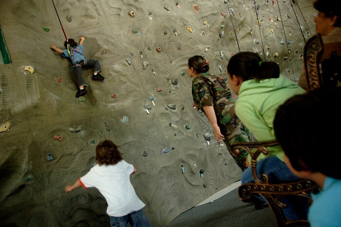 Jared Arredondo climbs the rock wall while he is cheered on by his family at the Outdoor Recreational Center on Charleston AFB May 7. Base members are allowed to pay to use the facilities at the ORC during the hours of 8 a.m. to 5 p.m. Monday through Friday. Jared, 7, is the son of Tech. Sgt. Mark and Staff Sgt. Jennifer Arrendondo. (U.S. Air Force photo/Senior Airman Nicholas Pilch)