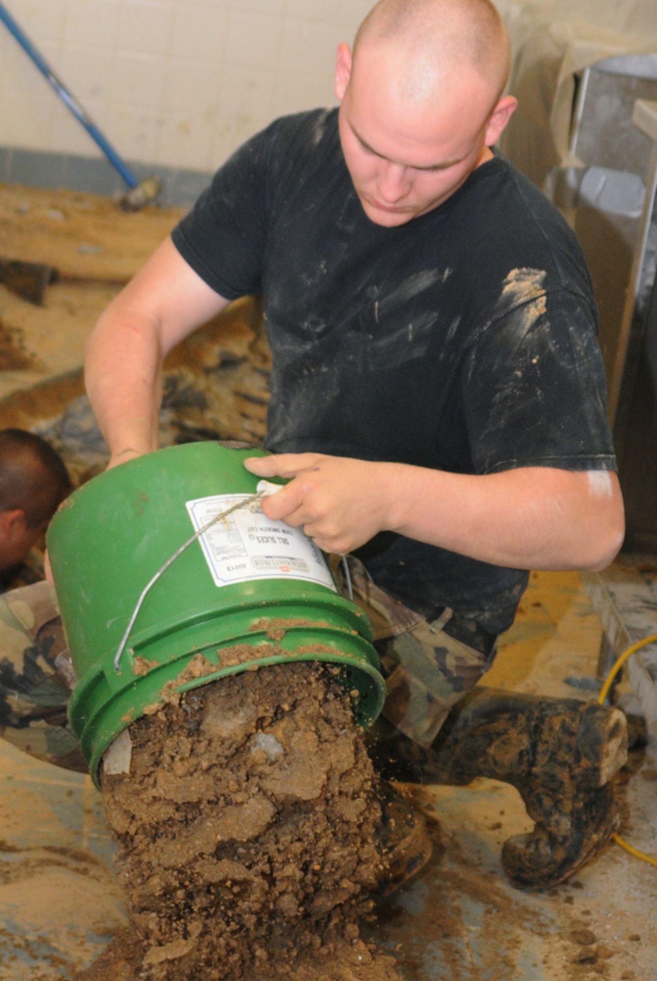 Senior Airman Matthew Griffin, 81st CES, dumps dirt shoveled from trenches where pipe is being laid.  (U.S. Air Force photo by Kemberly Groue)