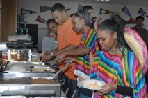MINOT AIR FORCE BASE, N.D. – Minot AFB Airmen help themselves to the free tacos provided by cooks from the Dakota Inn Dining Facility for the Cinco De Mayo festival at the Airman's Center here May  3. During the festival, a ribbon-cutting ceremony was held to re-open the recently remodeled Airman's Center. (U.S. Air Force photo by Senior Airman Cassandra Jones)