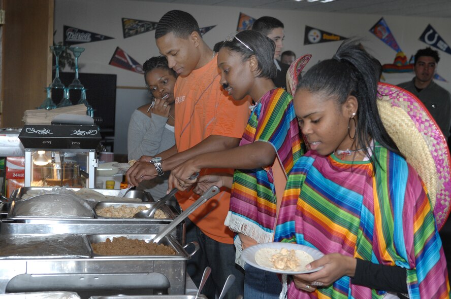 MINOT AIR FORCE BASE, N.D. – Minot AFB Airmen help themselves to the free tacos provided by cooks from the Dakota Inn Dining Facility for the Cinco De Mayo festival at the Airman's Center here May  3. During the festival, a ribbon-cutting ceremony was held to re-open the recently remodeled Airman's Center. (U.S. Air Force photo by Senior Airman Cassandra Jones)