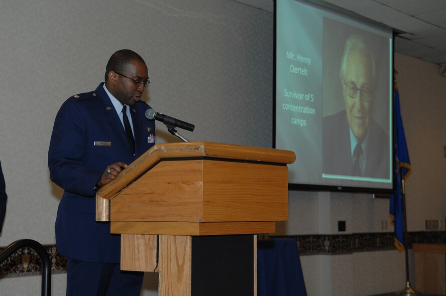 MINOT AIR FORCE BASE, N.D. -- Lt. Col. Robert Payne, 741st Missile Squadron director of operations, reads an excerpt from the book "An Unbroken Chain" by Henry Oertelt during the Holocaust Days of Remembrance luncheon held here April 29. During the luncheon, passages written by authors who survived the Holocaust were read by children from Memorial Middle School and Airmen from the base. (U.S. Air Force photo by Senior Airman Cassandra Jones)