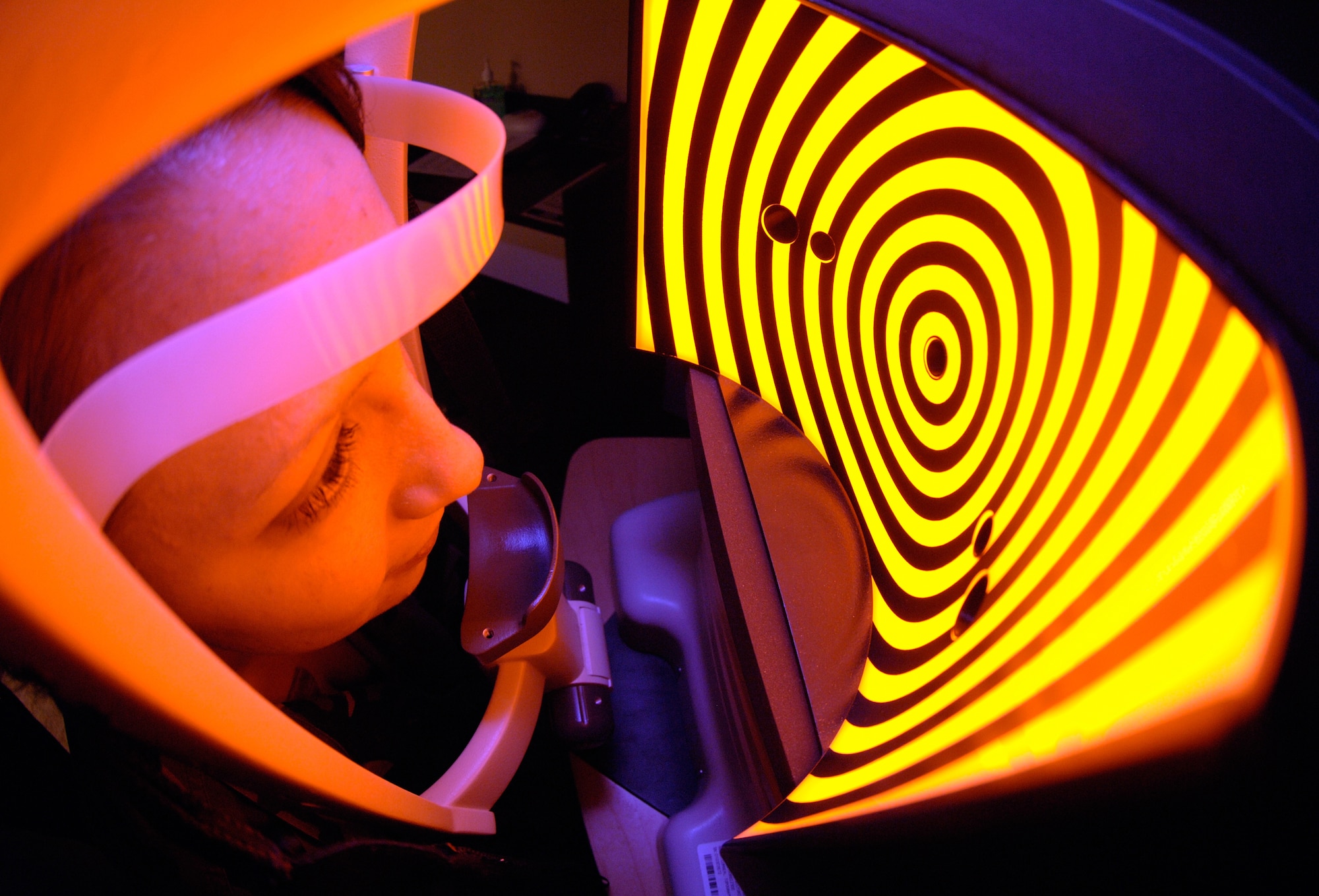 A patient recieves an orbscan using ultra sound to make an elevation map of her eyes at the Joint Refractive Surgery Center, Lackland Air Force Base, Texas, on March 28. An orbscan is one of the many tests an individual must go through to determine if they are a good canidate for laser eye surgery. (U.S. Air Force photo/Master Sgt. Kimberly A. Yearyean-Siers)