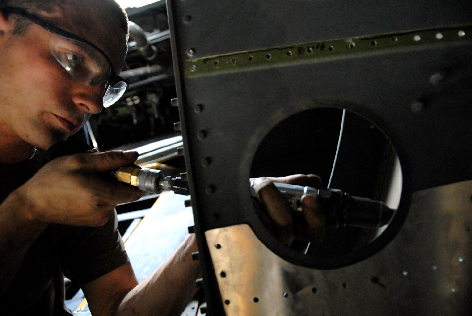SOUTHWEST ASIA -- Airman 1st Class Richard Clemons, an aircraft structural maintainer deployed to the 386th Expeditionary Maintenance Squadron metals flight, uses a drill to align holes on a piece of sheet metal that is being used as a patch for a repair on a C-130 Hercules May 6, 2008, at an air base in the Persian Gulf Region. The primary mission of the metals flight is to provide direct support to all of the structural components of an aircraft and its supporting equipment in support of the Global War on Terror. Airman Clemons is deployed from the 7th Equipment Maintenance Squadron, Dyess Air Force Base, Texas. (U.S. Air Force photo/ Staff Sgt. Patrick Dixon)