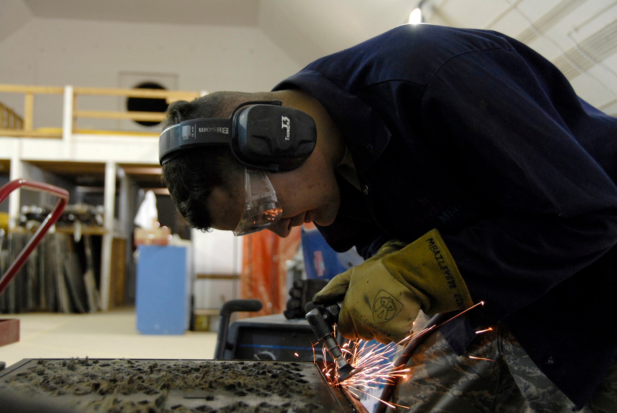 SOUTHWEST ASIA -- Senior Airman Jeremiah Oborn, an aircraft metals technician deployed to the 386th Expeditionary Maintenance Squadron metals flight, grinds down an aerospace ground equipment air conditioning panel May 6, 2008, at an air base in the Persian Gulf Region. The primary mission of the metals flight is to provide direct support to all of the structural components of an aircraft and its supporting equipment in support of the Global War on Terror. Airman Oborn is deployed from the 374th Maintenance Squadron, Yokota Air Base, Japan. (U.S. Air Force photo/ Staff Sgt. Patrick Dixon)