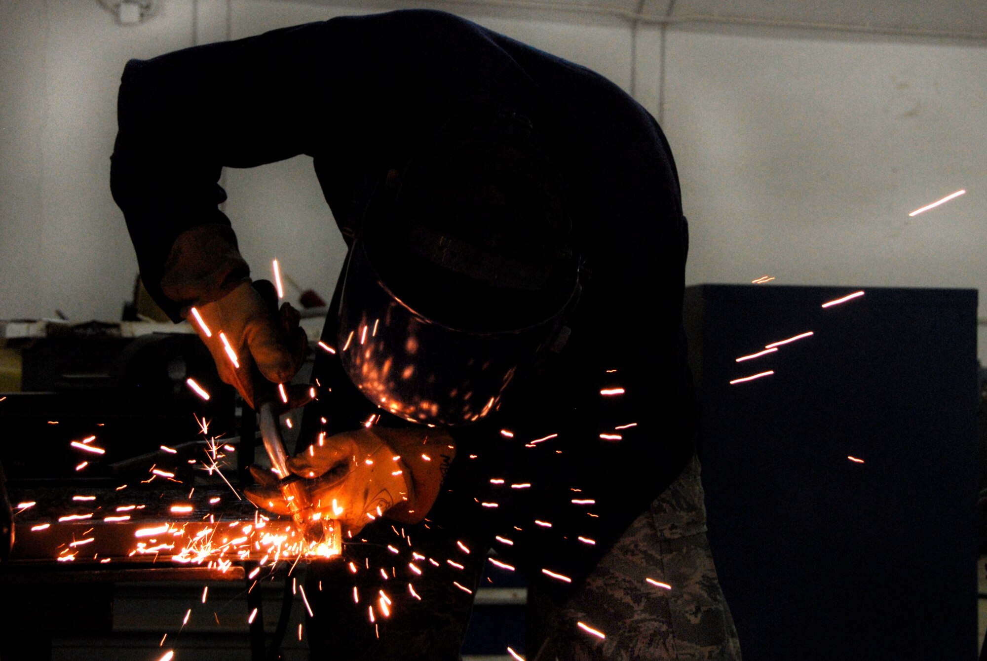 SOUTHWEST ASIA -- Senior Airman Jeremiah Oborn, an aircraft metals technician deployed to the 386th Expeditionary Maintenance Squadron metals flight, welds together an aerospace ground equipment air conditioning panel May 6, 2008, at an air base in the Persian Gulf Region. The primary mission of the metals flight is to provide direct support to all of the structural components of an aircraft and its supporting equipment in support of the Global War on Terror. Airman Oborn is deployed from the 374th Maintenance Squadron, Yokota Air Base, Japan. (U.S. Air Force photo/ Staff Sgt. Patrick Dixon)