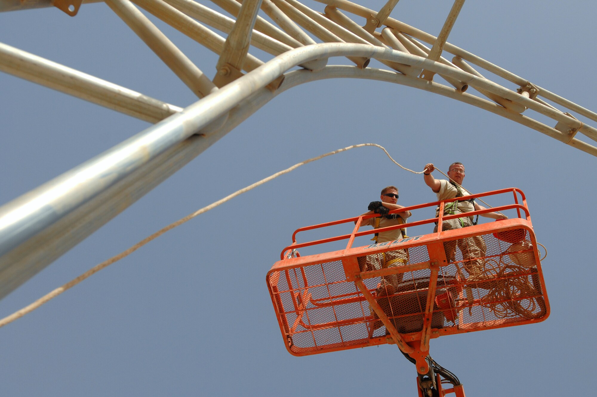 BALAD AIR BASE, Iraq -- Staff Sgt. Karl Ferree, 332nd Expeditionary Civil Engineer Squadron structural engineer, raises a lead rope over the skeleton of a big top shelter here, May 7. The shelter was moved from its previous location to de-conflict flightline operations. Sergeant Ferree is deployed from Luke Air Force Base, Ariz. (U.S. Air Force photo/ Senior Airman Julianne Showalter)