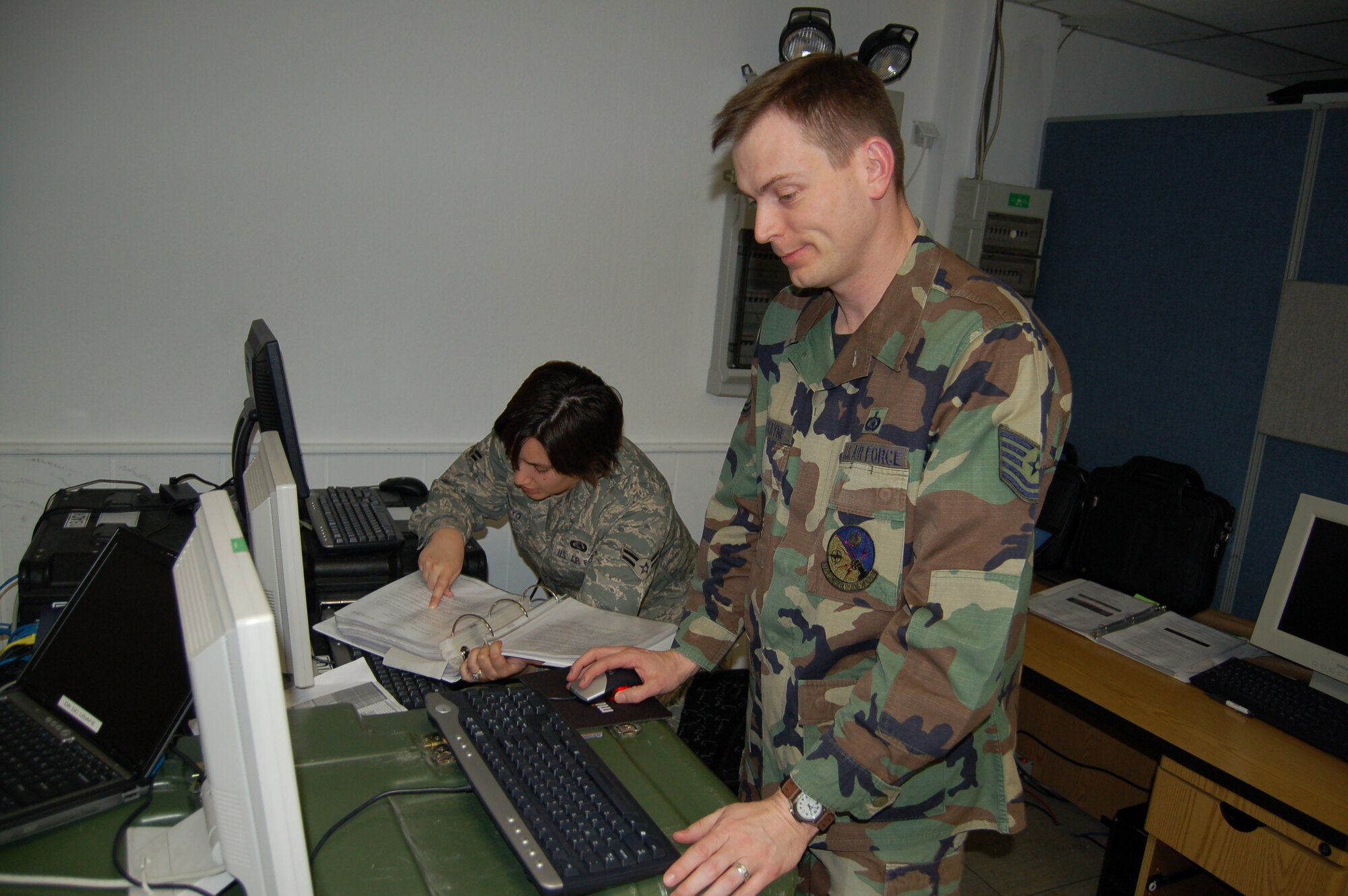Tech. Sgt. Derron Cockayne and Airman 1st Class Jessica Arroyo, both from the 1st Air and Space Communications Operations Squadron, install software updates to the TBMCS-UL Theater Deployable Kit. There are only two of these kits maintained in the U.S. Air Forces in Europe command.(Courtesy Photo) 