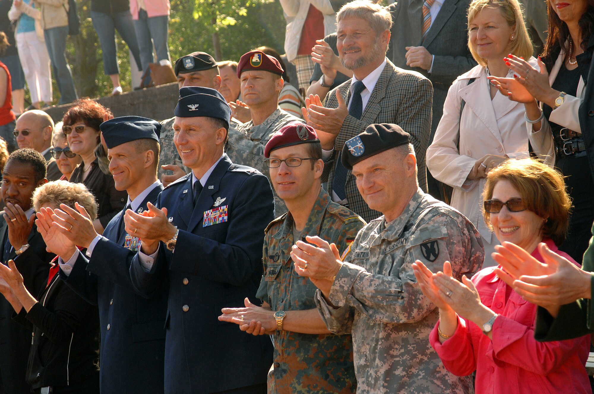 (Lft to Rt) 86th Airlift Wing Command Chief Master Sgt. Steve McDonald, 86th AW Commander Col. Bill Bender, Bundeswehr representative of the Kaiserslautern County for military-civilian cooperation Oberstleutnant (Lt. Col.) Stefan Roth, 21st Theater Sustainment Commanding General Maj. Gen. Yves Fontaine and his wife Kathy, cheer on the participants of  the Special Olympics Spring Games, during the opening parade at Enkenbach-Alsenborn May 6. This is the 25th year of the U. S. Army Garrison Kaiserslautern Special Olympics, which is an international program of athletic competition for children and adults with special needs. (U.S. Air Force photo by TSgt Kenneth Bellard) (Released*)

