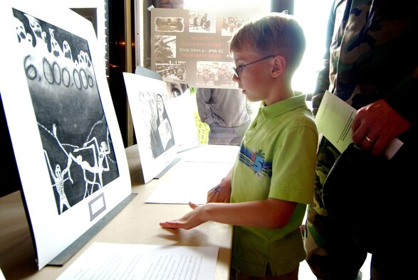 Spencer Clementz, 8, and his father, Maj. Dominic Clementz, 18th Maintenance Operations Squadron commander, look at art provided by students from Kadena High School during the Days of Remembrance ceremony at Kadena Air Base, Japan, May 2.
(U.S. Air Force photo/Tech. Sgt. Rey Ramon)