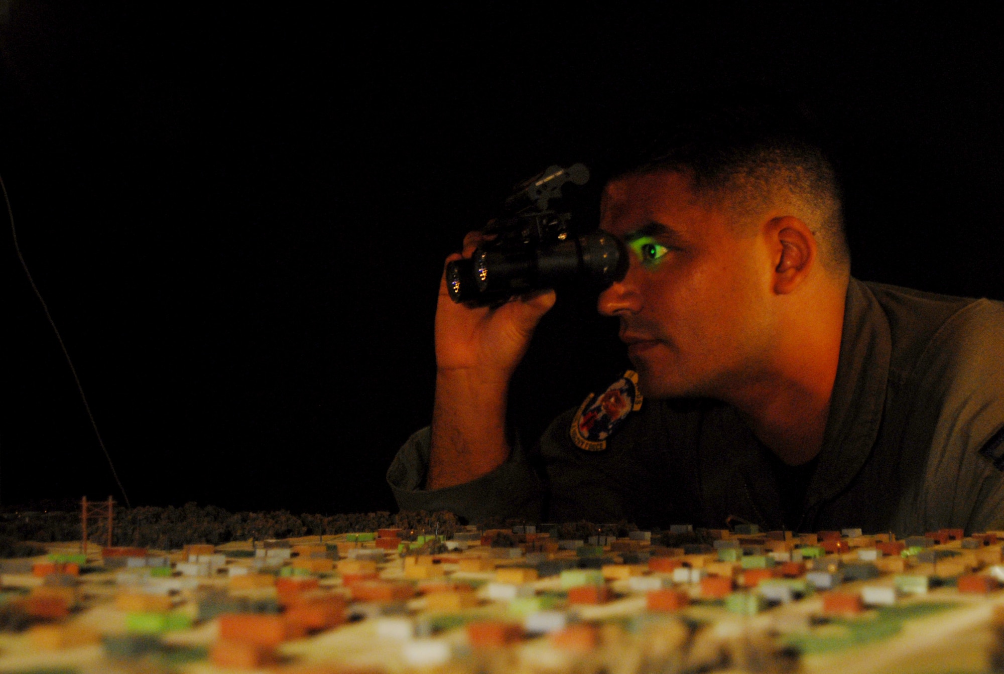 Capt. Alejandro Romas, 18th Aerospace Medicine Squadron officer in charge of
the Aerospace Physiology Operations Element, views the demonstration table
within the Night Imaging and Threat Evaluation lab at Kadena Wednesday using
a pair of night-vision goggles.  The lab teaches two separate night-vision
courses to members of the 18th Wing Security Forces and Airmen using aircrew
flight equipment in order to orient them with the use of the technology.
(U.S. Air Force photo/Staff Sgt. Christopher Marasky)