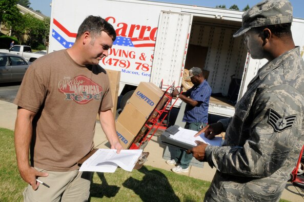 TSgt. Chris Altham, 339th Flight Test Squadron aircrew flight equipment, confers with SSgt. Clarence Lee, 78th Logistic Readiness Squadron quality control inspector about the moving of his household goods. Sgt. Altham is coming to Robins from Patrick Air Force Base. U. S. Air Force photo by Sue Sapp