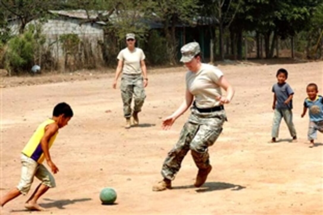 U.S. Army Spc. Teri McMurray, a medic assigned to the 4005th Army Hospital, plays soccer with local children at a school renovation site in La Mesas, Honduras, May 2, 2008. McMurray and her unit are taking part in Beyond the Horizons, a joint training exercise in which U.S. and Honduran soldiers conduct humanitarian and civil assistance missions while developing their engineering, construction and medical skills.