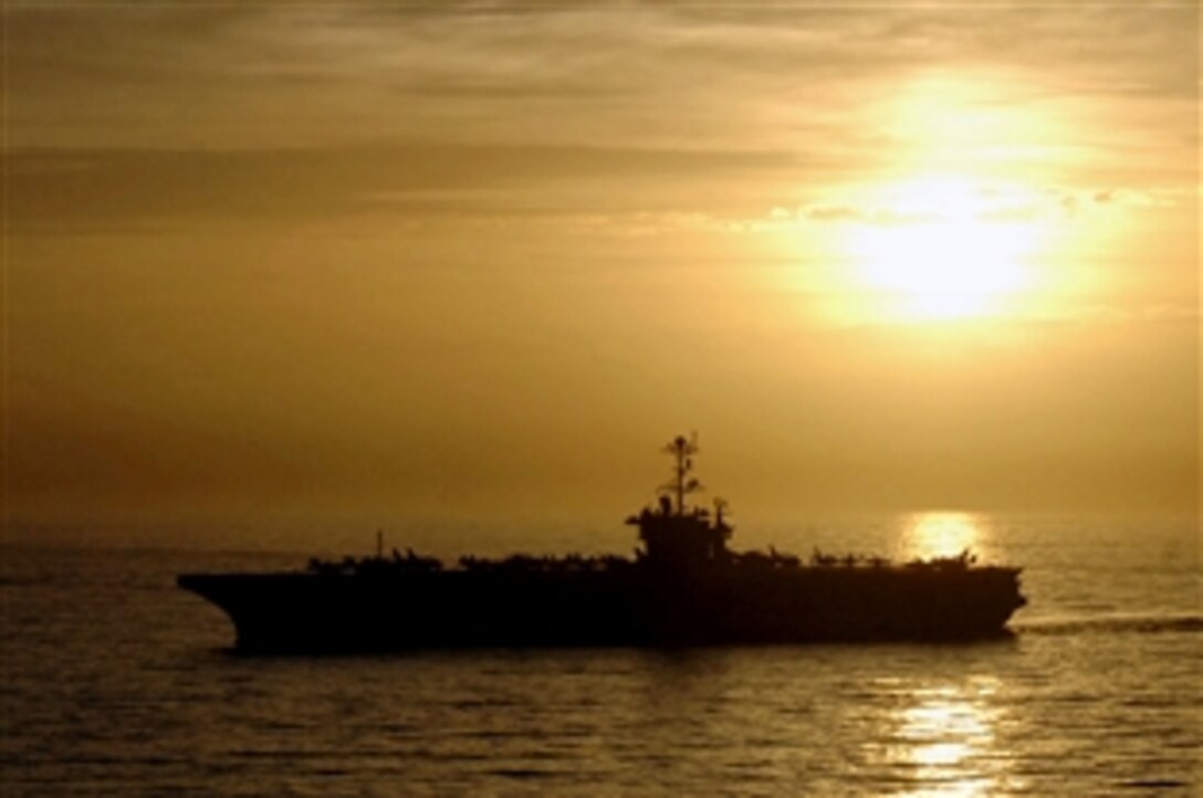 The aircraft carrier USS George Washington sails in the Pacific Ocean as the sun breaks over the horizon, May 6, 2008. The USS Washington is participating in Partnership of the Americas 2008, a multinational exercise designed to enhance regional security and maritime partnership. 