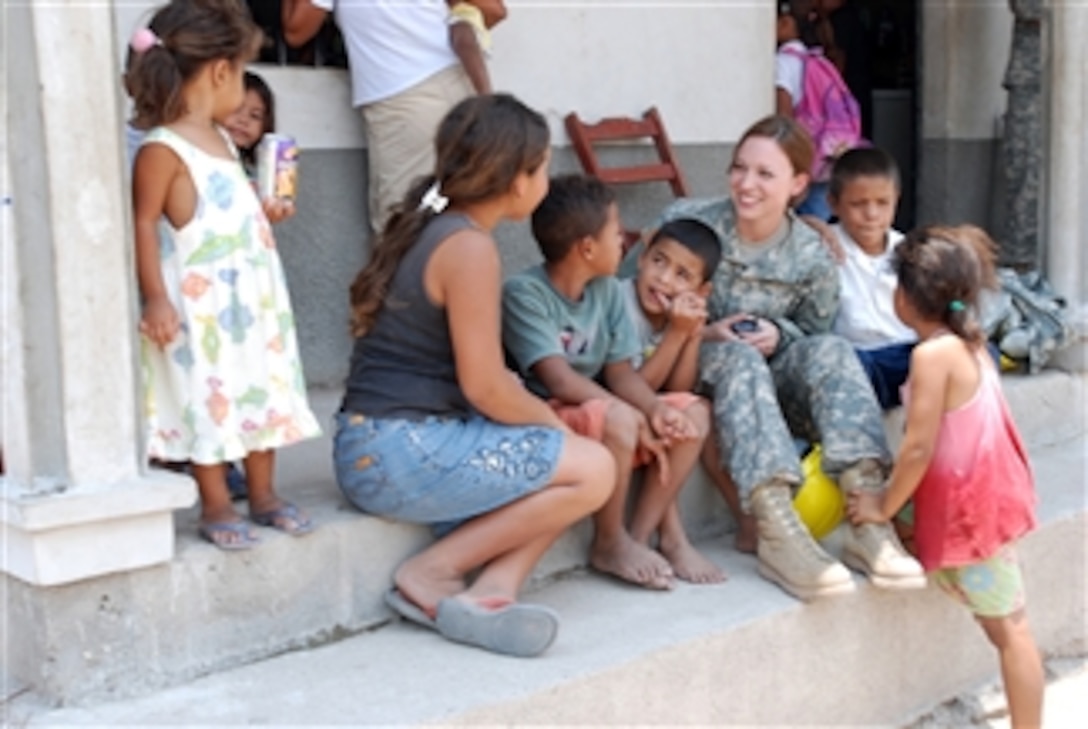 U.S. Army 2nd Lt. Frances Lamb interacts with local children.