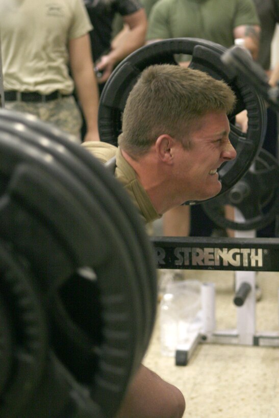 Petty Officer 3rd Class Gabriel Sprigel, a hull technician with Rivron Squadron 1, 1st Marine Expeditionary Force, Regimental Combat Team 5, squats 350 pounds during the superman competition at the Marine Welfare and Recreation Center in Al Qa'im, Iraq, May 8. Events like this take place monthly at the MWR.